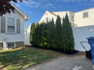 Trimmed hedge row and fresh mulch beds